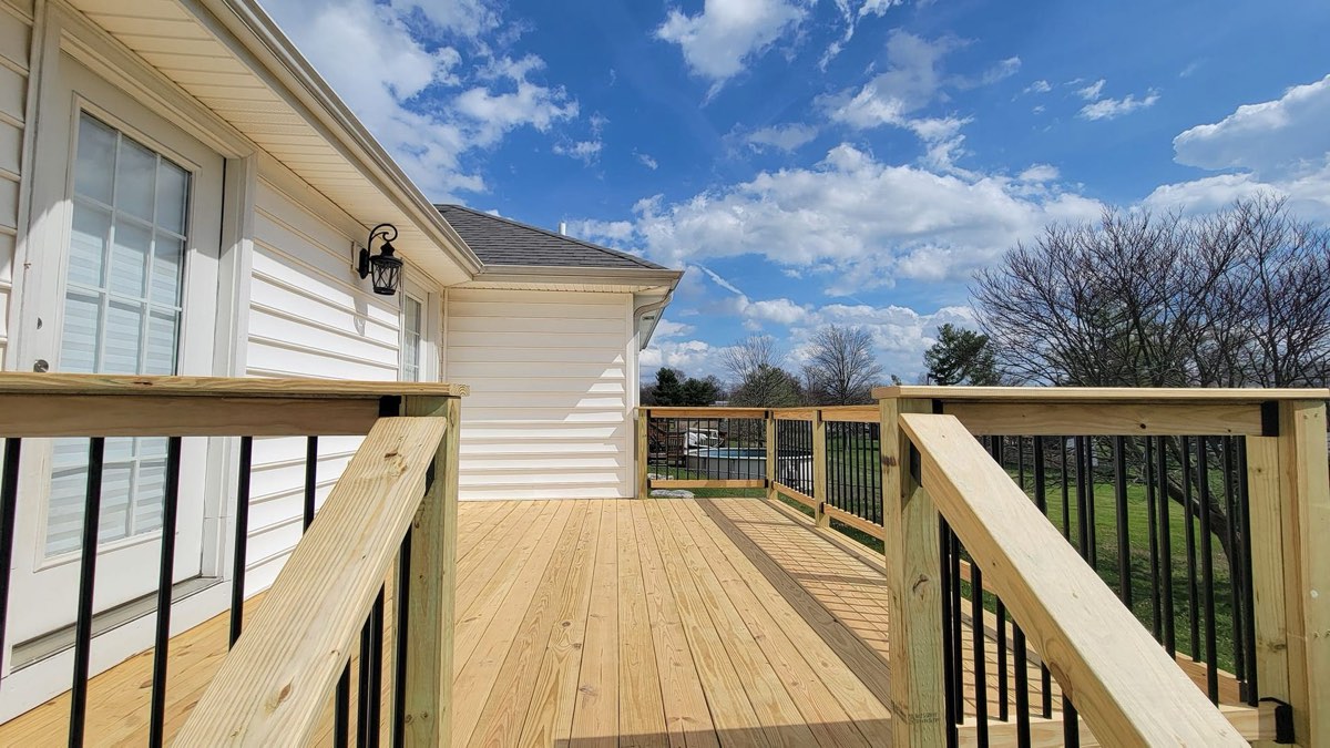 Custom wood deck with Ben Scott's signature black steel balusters