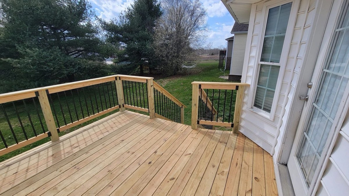 Finished wood deck with black steel balusters in Danville