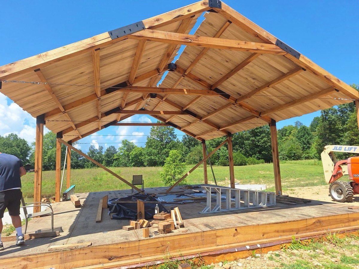 Crew setting the timber rafters on an open pavilion frame at a Central Kentucky build site